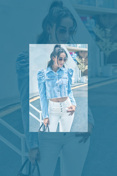 nekkidnow.com Woman wearing a light blue denim jacket and white pants, holding a black handbag.
