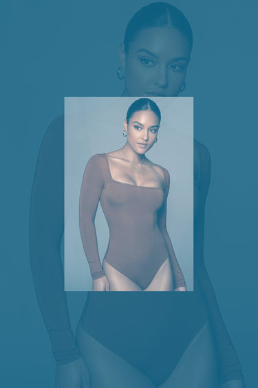 nekkidnow.com Woman wearing a brown long-sleeve bodysuit with a blurred background